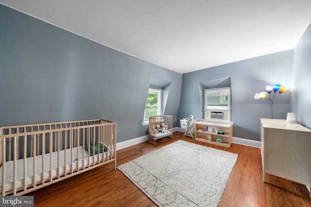 1002 W 9th St, Wilmington, DE 19806 - bedroom featuring wood finished floors, a nursery area, and cooling unit