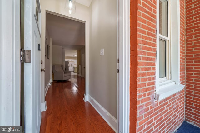 1002 W 9th St, Wilmington, DE 19806 - corridor featuring dark wood-style flooring and brick wall