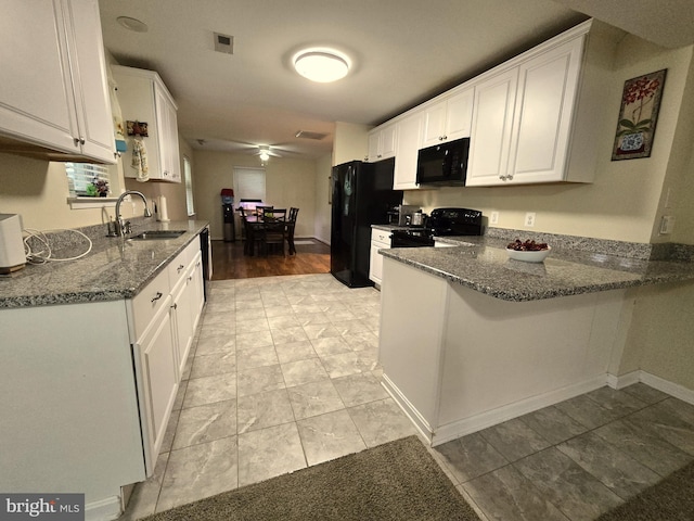 14722 Banks Odee Rd, Newburg, MD 20664 - kitchen featuring black appliances, a peninsula, white cabinetry, dark stone countertops, and a ceiling fan