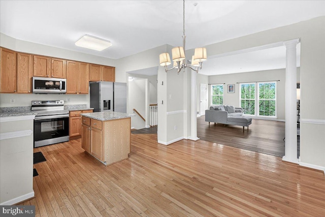 13102 Alpine Dr Unit 2502, Germantown, MD 20874 - kitchen featuring appliances with stainless steel finishes, open floor plan, light wood-style flooring, and a center island