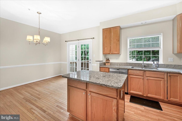 13102 Alpine Dr Unit 2502, Germantown, MD 20874 - kitchen with stainless steel dishwasher, light wood-style floors, a chandelier, decorative light fixtures, and a center island