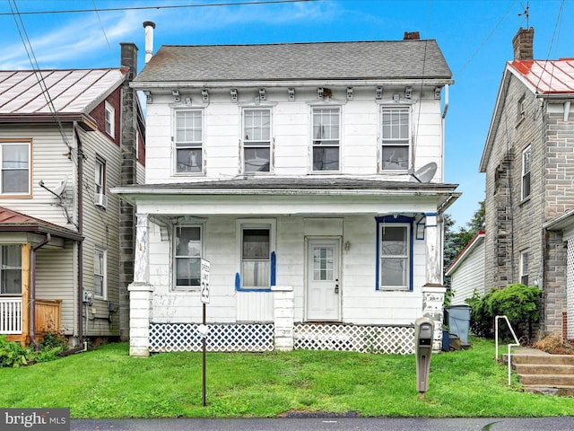 543 W Main Ave, Myerstown, PA 17067 - view of front facade with a porch and a front lawn