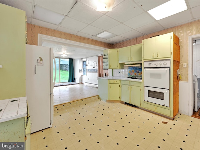 543 W Main Ave, Myerstown, PA 17067 - kitchen featuring wallpapered walls, white appliances, green cabinetry, a paneled ceiling, and light flooring