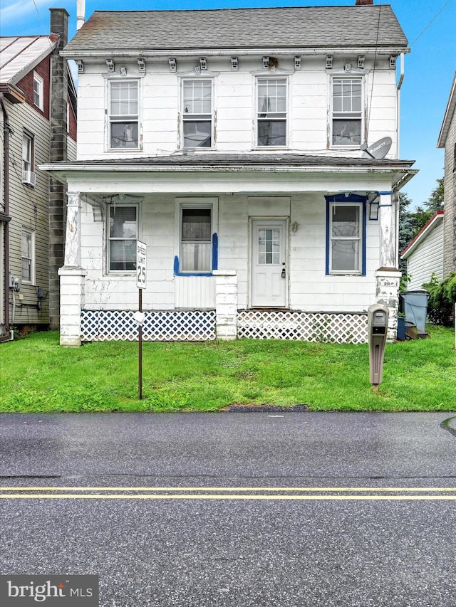 543 W Main Ave, Myerstown, PA 17067 - townhome / multi-family property featuring covered porch, a chimney, and a front lawn