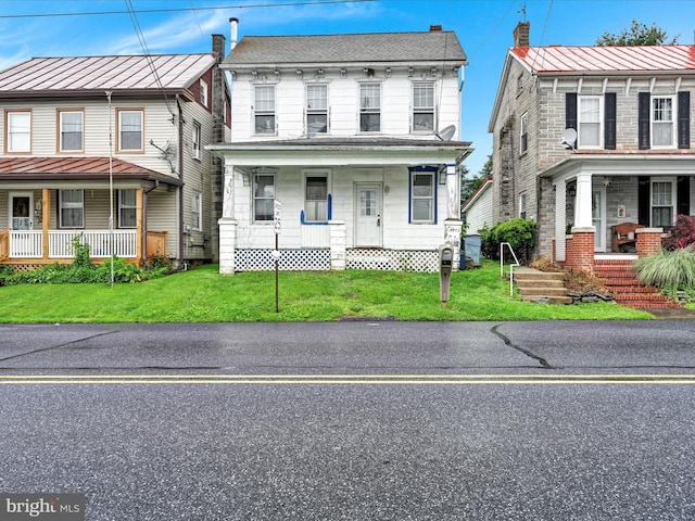 543 W Main Ave, Myerstown, PA 17067 - townhome / multi-family property featuring a porch and a front lawn