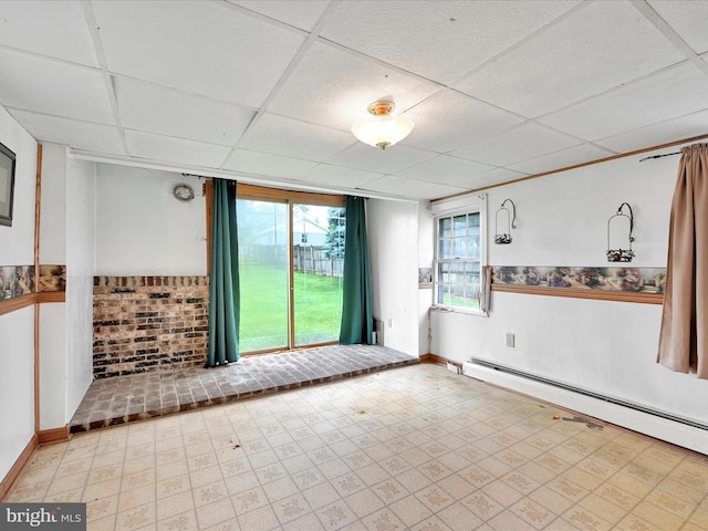 543 W Main Ave, Myerstown, PA 17067 - unfurnished room featuring a baseboard radiator, a drop ceiling, light floors, and a wainscoted wall
