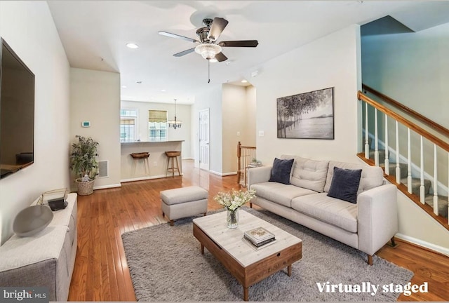 7226 Abbey Rd, Elkridge, MD 21075 - living area featuring ceiling fan, wood finished floors, stairway, recessed lighting, and a chandelier