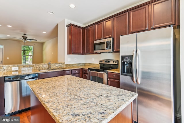 7226 Abbey Rd, Elkridge, MD 21075 - kitchen with appliances with stainless steel finishes, recessed lighting, light stone countertops, ceiling fan, and a kitchen island