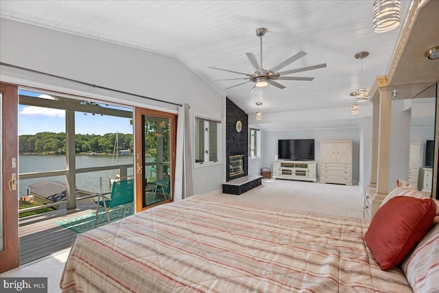 194 Harbor Dr, Lusby, MD 20657 - bedroom with multiple windows, access to outside, vaulted ceiling, a large fireplace, and carpet floors