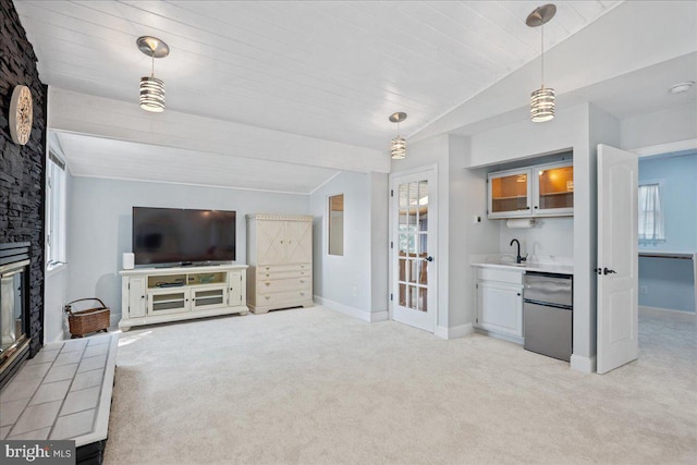 194 Harbor Dr, Lusby, MD 20657 - unfurnished living room featuring lofted ceiling, light colored carpet, healthy amount of natural light, and wet bar