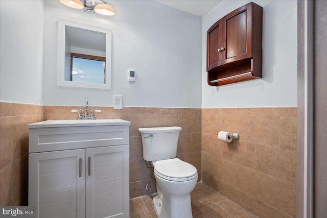 194 Harbor Dr, Lusby, MD 20657 - bathroom featuring tile walls, a wainscoted wall, vanity, and tile patterned floors