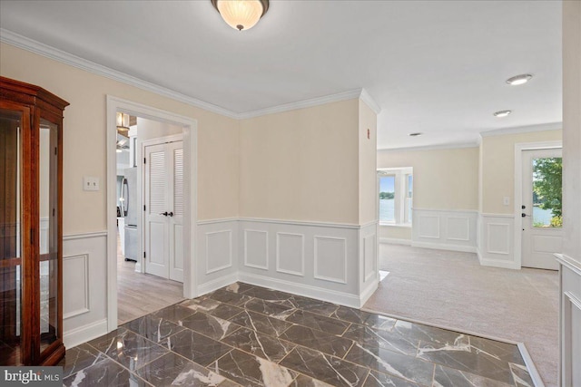 194 Harbor Dr, Lusby, MD 20657 - hall featuring crown molding, wainscoting, a decorative wall, and marble finish floors