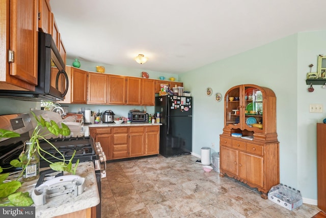 54 Victory Way, Royersford, PA 19468 - kitchen with black appliances, light countertops, and brown cabinets