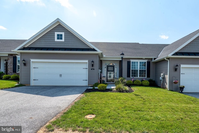 612 Cypress Dr Unit 51, Hanover, PA 17331 - view of front of home with a standing seam roof, asphalt driveway, a front lawn, and a metal roof