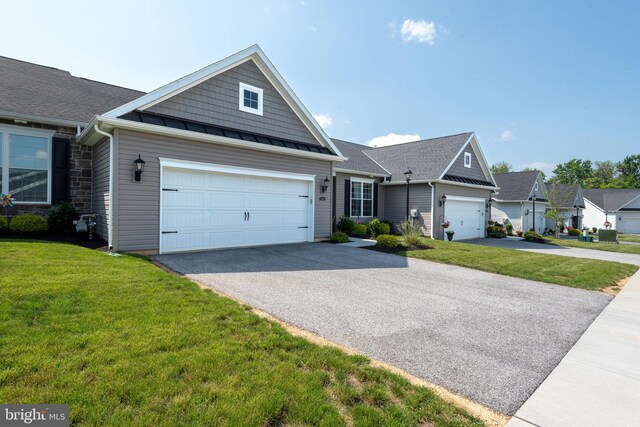 612 Cypress Dr Unit 51, Hanover, PA 17331 - view of front facade with driveway, a front lawn, a garage, and a standing seam roof