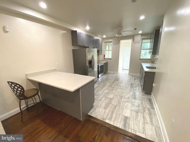 75 New York Ave NW, Washington, DC 20001 - kitchen with appliances with stainless steel finishes, light countertops, a peninsula, a ceiling fan, and recessed lighting