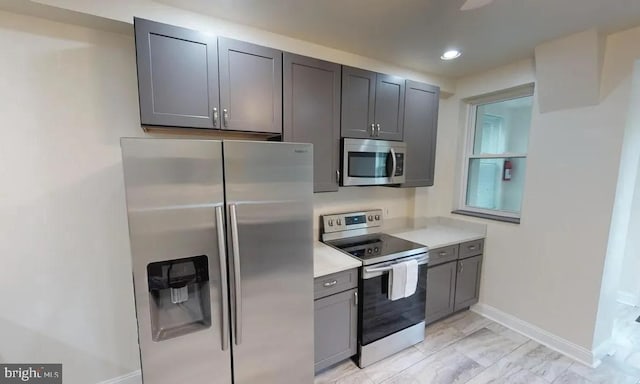 75 New York Ave NW, Washington, DC 20001 - kitchen featuring appliances with stainless steel finishes, gray cabinets, light countertops, recessed lighting, and light marble finish flooring