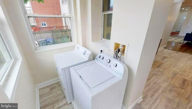 75 New York Ave NW, Washington, DC 20001 - washroom with washing machine and clothes dryer and baseboards