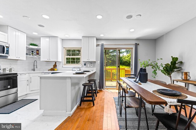 8 Cross Falls Cir, Sparks Glencoe, MD 21152 - kitchen with stainless steel appliances, open shelves, light countertops, tasteful backsplash, and recessed lighting