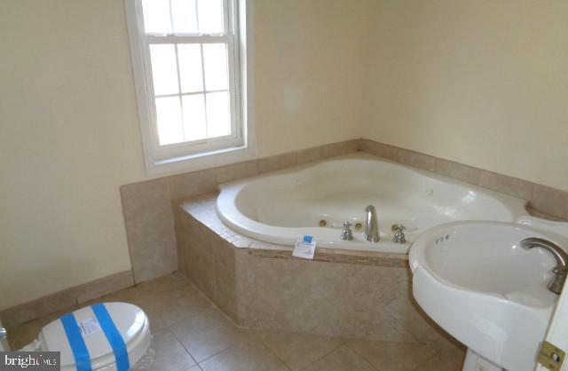 4365 Family Cir, Prince Frederick, MD 20678 - bathroom with a bath and tile patterned floors