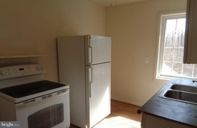 4365 Family Cir, Prince Frederick, MD 20678 - kitchen featuring white appliances, light wood-style flooring, and healthy amount of natural light
