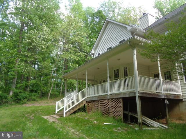 4365 Family Cir, Prince Frederick, MD 20678 - view of home's exterior featuring a chimney, a porch, and a yard