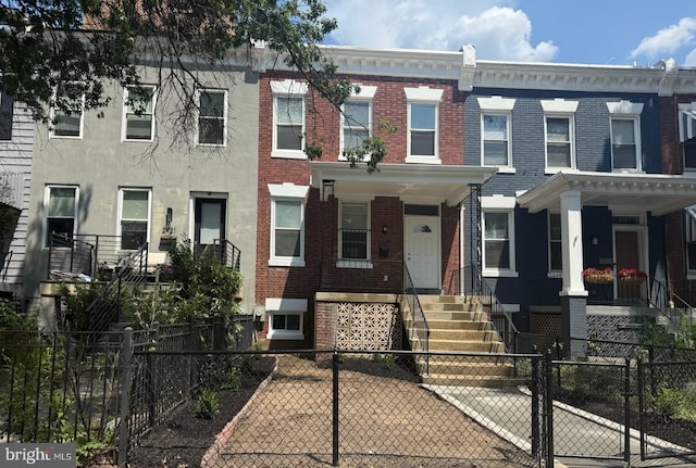 2419 N Capitol St NE, Washington, DC 20002 - townhome / multi-family property with brick siding, a gate, and a fenced front yard