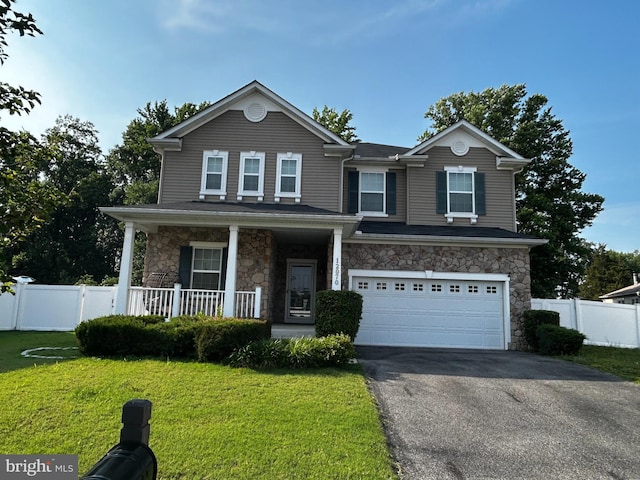 12070 Mustard Seed Ct, Waldorf, MD 20601 - view of front of property with stone siding, asphalt driveway, a garage, and covered porch