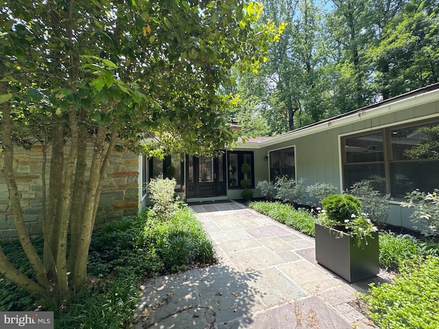 property entrance with stone siding