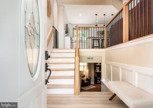 6444 Duhollow Rd, Warrenton, VA 20187 - entrance foyer featuring wood finished floors, a decorative wall, wainscoting, stairway, and recessed lighting