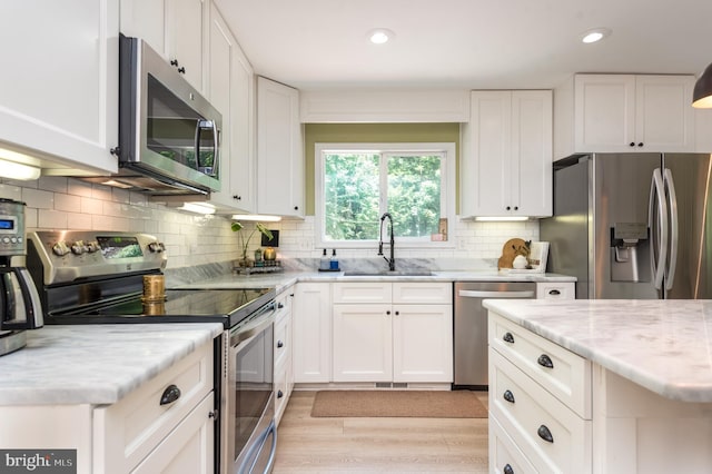 6444 Duhollow Rd, Warrenton, VA 20187 - kitchen with appliances with stainless steel finishes, white cabinets, light stone countertops, and recessed lighting