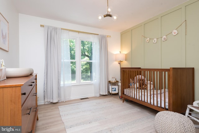 6444 Duhollow Rd, Warrenton, VA 20187 - bedroom featuring light wood-type flooring, a nursery area, and a chandelier