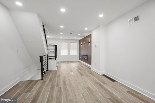 239 Rubicam St, Philadelphia, PA 19120 - unfurnished living room featuring stairs, light wood-type flooring, and recessed lighting