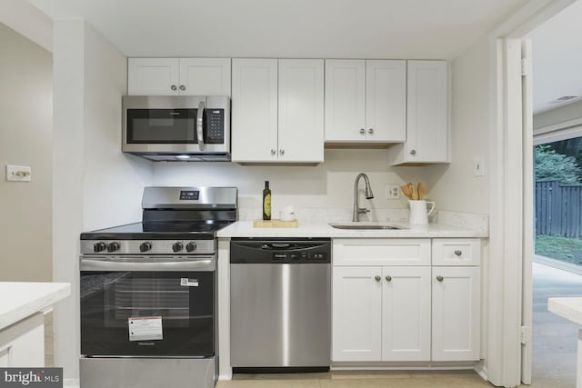 1814 Ivy Oak Sq, Reston, VA 20190 - kitchen with stainless steel appliances, white cabinetry, and light stone counters
