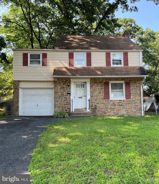 102 Forest Dr, Wilmington, DE 19804 - view of front facade featuring stone siding, asphalt driveway, a front lawn, a garage, and a chimney