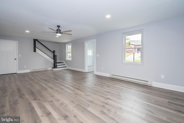 511 E Green St, Oakland, MD 21550 - unfurnished living room with a baseboard radiator, stairway, recessed lighting, wood finished floors, and a ceiling fan