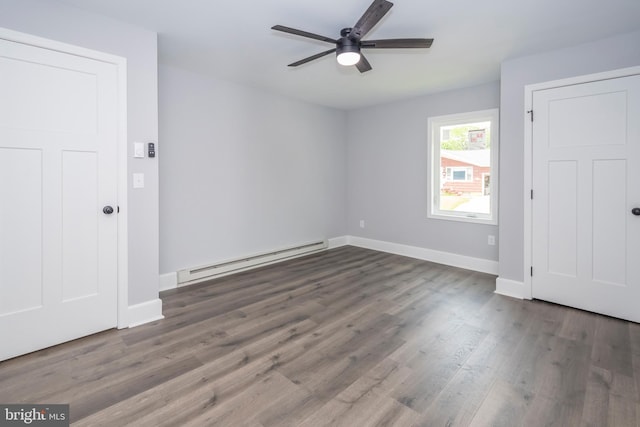 511 E Green St, Oakland, MD 21550 - unfurnished bedroom with a baseboard heating unit, wood finished floors, and a ceiling fan