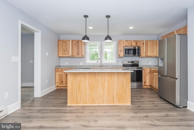 511 E Green St, Oakland, MD 21550 - kitchen with stainless steel appliances, light brown cabinets, a center island, light wood finished floors, and recessed lighting