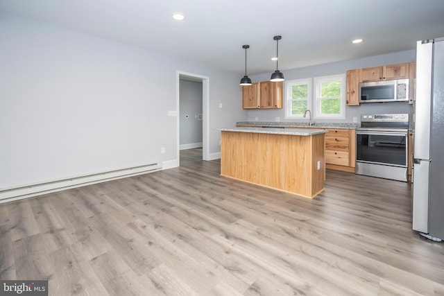 511 E Green St, Oakland, MD 21550 - kitchen with stainless steel appliances, a kitchen island, light wood-style floors, light countertops, and recessed lighting