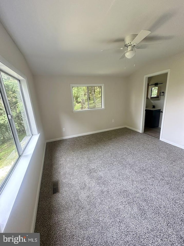 556 Trapper Ridge Ln, Hedgesville, WV 25427 - spare room featuring baseboards and a ceiling fan