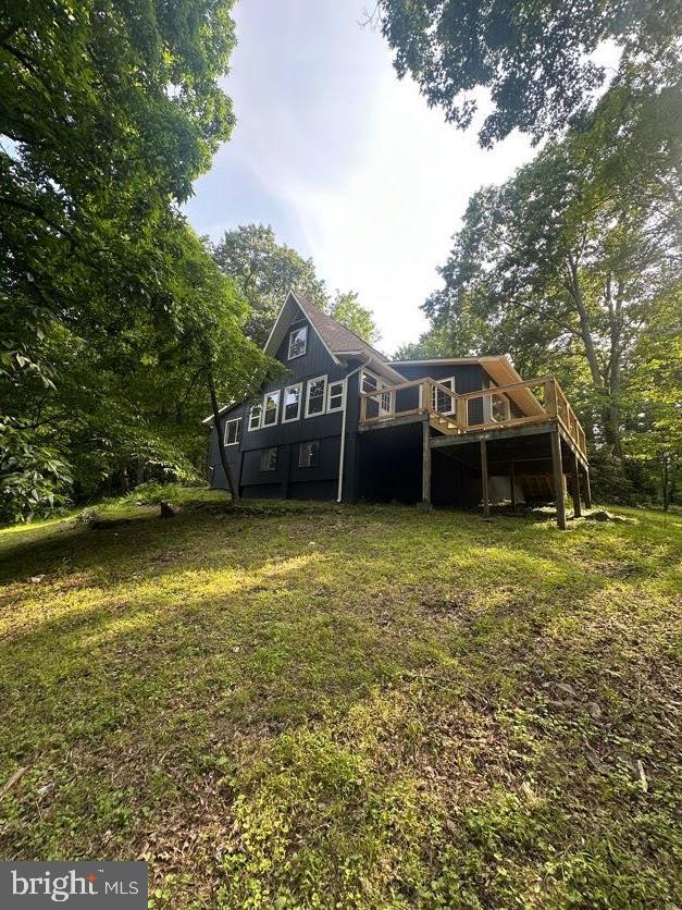 556 Trapper Ridge Ln, Hedgesville, WV 25427 - rear view of house featuring a wooden deck and a lawn