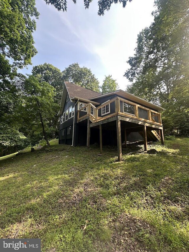 556 Trapper Ridge Ln, Hedgesville, WV 25427 - rear view of house featuring a wooden deck and a lawn