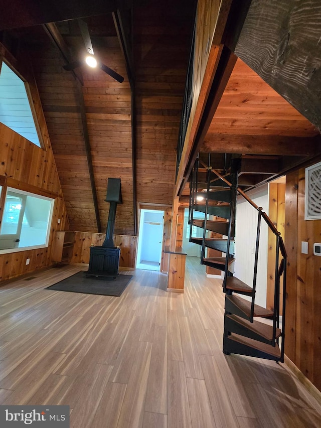 556 Trapper Ridge Ln, Hedgesville, WV 25427 - additional living space featuring wood walls, wood finished floors, stairs, a wood stove, and wood ceiling