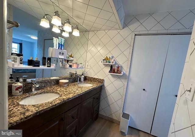 1239 Vermont Ave NW Unit 902, Washington, DC 20005 - full bathroom featuring wood finished floors, double vanity, and tile walls