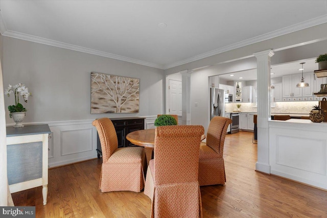 5304 Braddock Ridge Dr, Centreville, VA 20120 - dining area with decorative columns, wood finished floors, crown molding, and wainscoting