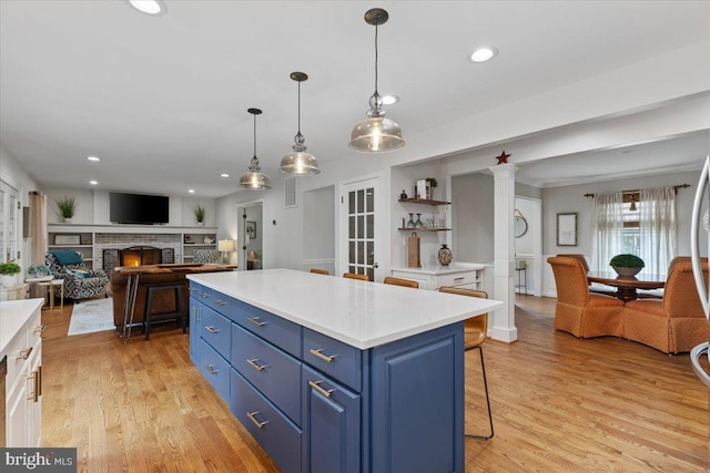 5304 Braddock Ridge Dr, Centreville, VA 20120 - kitchen featuring blue cabinetry, light wood finished floors, light countertops, recessed lighting, and a kitchen island