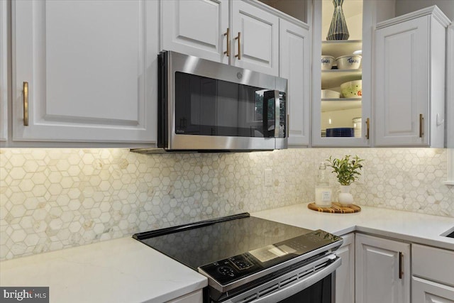 5304 Braddock Ridge Dr, Centreville, VA 20120 - kitchen featuring stainless steel appliances, white cabinets, glass insert cabinets, and backsplash