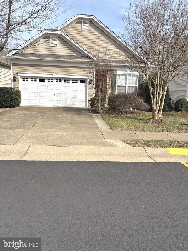 view of front of property featuring concrete driveway and a garage