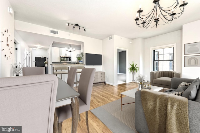 1111 25th St NW Unit 521, Washington, DC 20037 - living room with a chandelier and light wood-style flooring