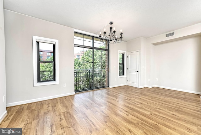 1111 25th St NW Unit 521, Washington, DC 20037 - unfurnished room with a chandelier and light wood finished floors